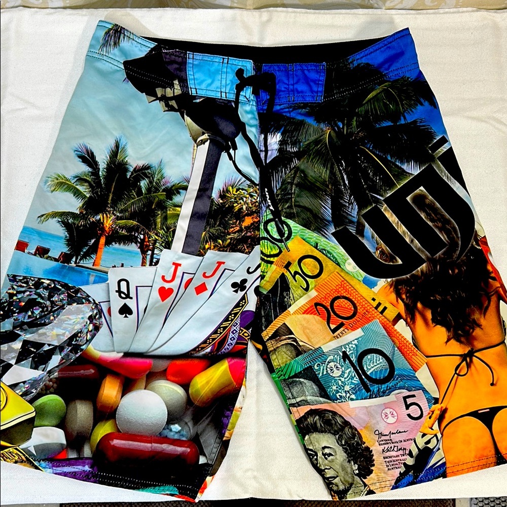 Vibrant Blue and Green Board Shorts with Tropical Design
